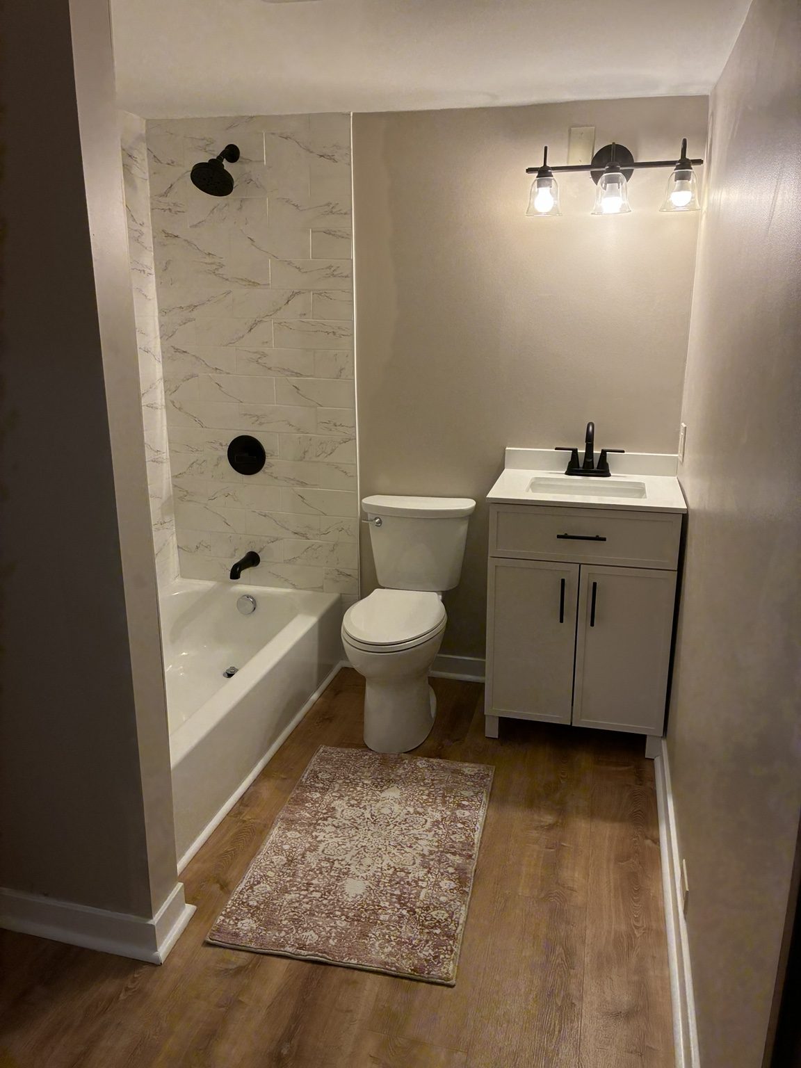 Bathroom with vanity and tub surround